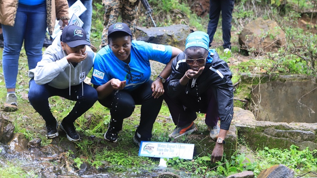 Kenyan hip-hop artist and WWF-Kenya council ambassador member Juliani and WWF-Kenya staff drinking water from River Timau, a tributary of River Njoro.
